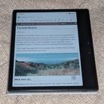 The ebook reader is showing a web browser with tabs and a toolbar along the top. The website displayed is a review of a nature reserve, and while the landscape photo is recognizable, the color is not very smooth or bright. More like a pointilist watercolor.