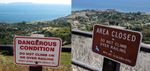 Two signs on a fence looking out at a hillside down to the ocean, separated by several years (and different seasons). The older sign is printed red on a white background, and says DANGEROUS CONDITION - DO NOT CLIMB ON OR OVER RAILING - DON'T EVEN THINK ABOUT IT! The newer sign is white on brown, and just says AREA CLOSED - DO NOT CLIMB OVER RAILING. But hey, it's got the municipal code listed on it.