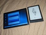 PineTab2 and a Boox Poke3 eReader for scale. A tablet computer, about the size of two eBook readers placed next to each other. The tablet is displaying a Linux desktop environment with icons along the left, a taskbar along the bottom, and a web browser's view of a social media timeline. (The website looks like the old Windows XP theme. It's GoToSocial.)